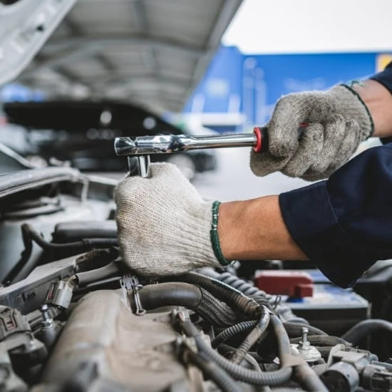 ASE-certified mechanic torquing under the hood at Allied Auto Services in Roselle